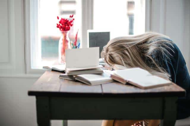 exhausted-woman-with-head-on-desk