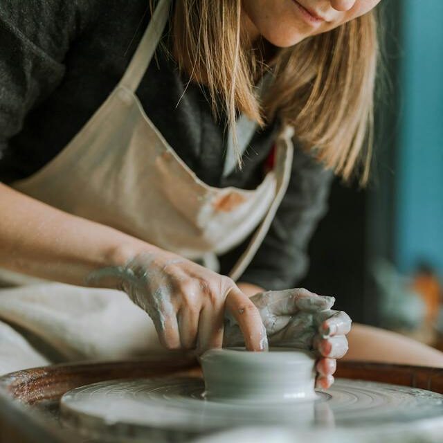 woman spinning pottery