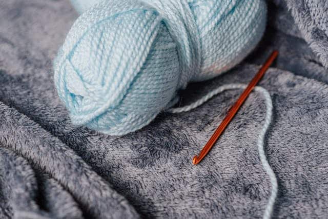 ball of yarn and crochet needle
